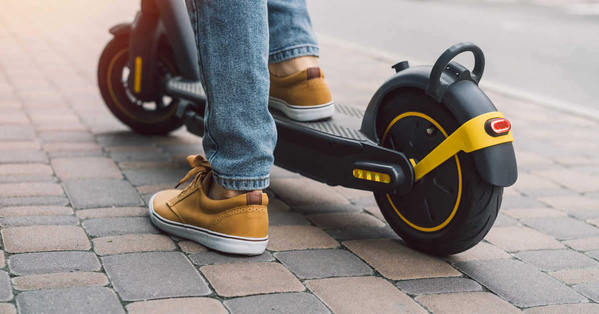 Person travelling on an e-scooter